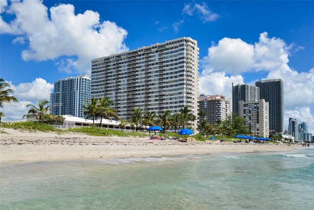 view of property featuring a city view, a beach view, and a water view