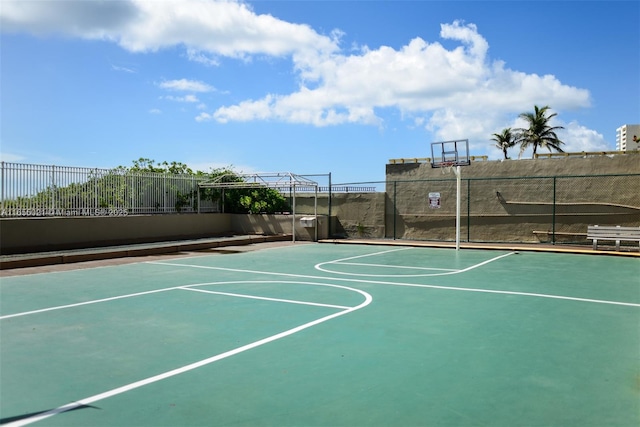 view of basketball court with community basketball court and fence