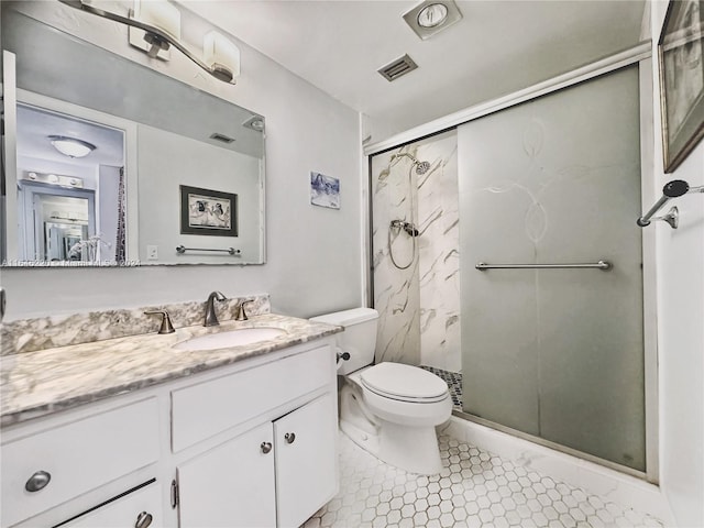 bathroom featuring tile patterned flooring, a shower with door, vanity, and toilet