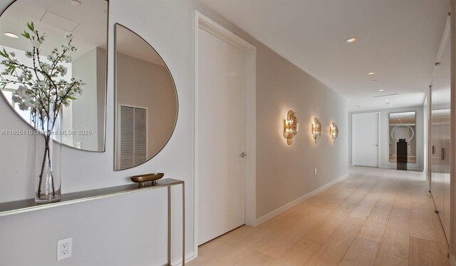 corridor with light hardwood / wood-style floors