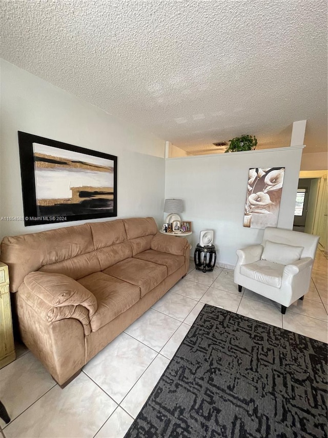 living room featuring light tile patterned floors and a textured ceiling