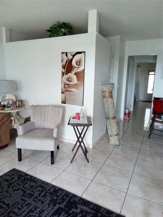 sitting room featuring light tile patterned floors and a textured ceiling