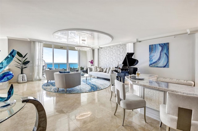 living room featuring expansive windows, ornamental molding, a water view, and a notable chandelier