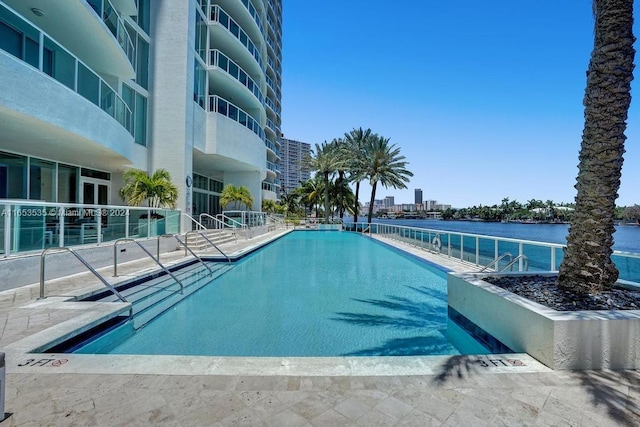 view of pool featuring a water view