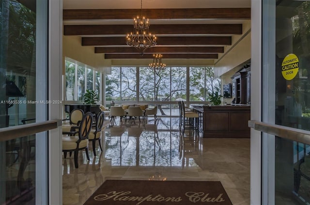 unfurnished sunroom with beamed ceiling and a notable chandelier