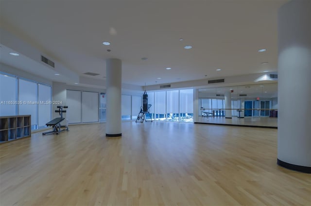 workout room with recessed lighting, wood finished floors, and visible vents