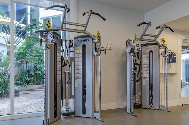 gym featuring baseboards and a wealth of natural light