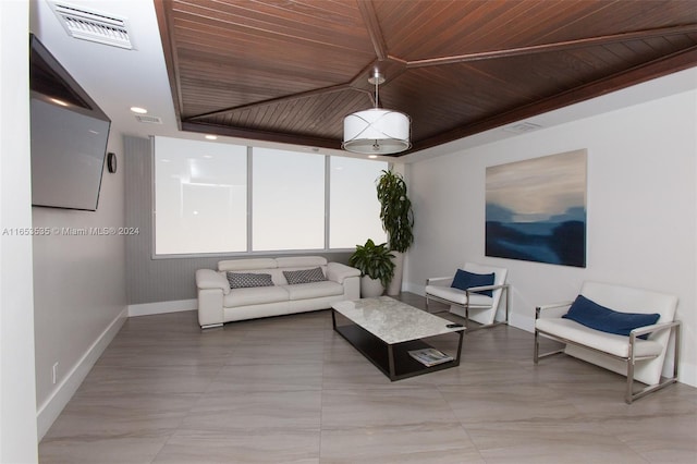living room featuring baseboards, visible vents, and wood ceiling