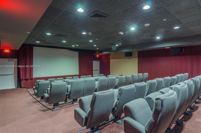 home theater featuring visible vents, carpet flooring, and a drop ceiling