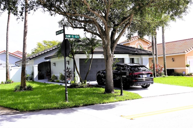 view of front facade with a front yard and a garage