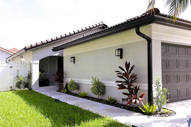 exterior space featuring a garage and a front lawn