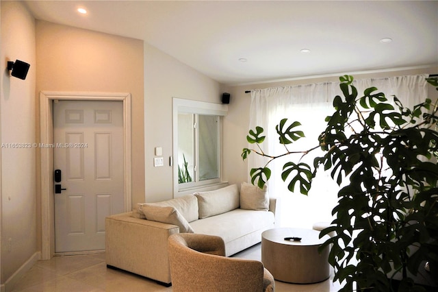 living room with vaulted ceiling and light tile patterned floors