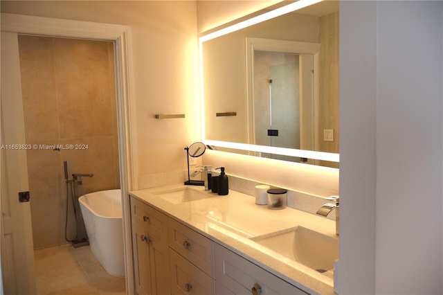 bathroom with a bath, tile patterned flooring, and vanity