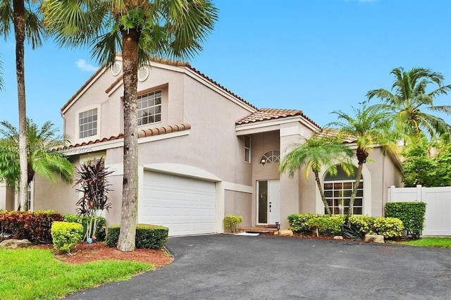 mediterranean / spanish house featuring a garage