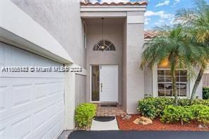 view of exterior entry featuring a garage