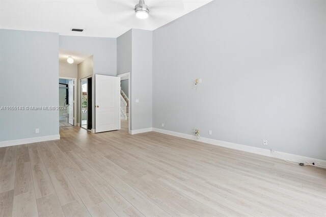 unfurnished room with ceiling fan and light wood-type flooring