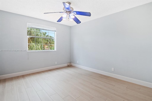 empty room with ceiling fan, light hardwood / wood-style floors, and a textured ceiling