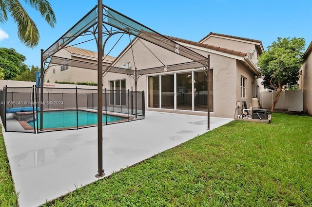 back of house featuring a fenced in pool, a yard, and a patio