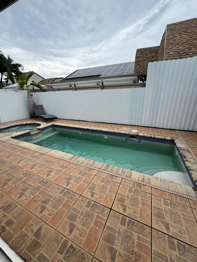 view of pool with a patio area and an in ground hot tub