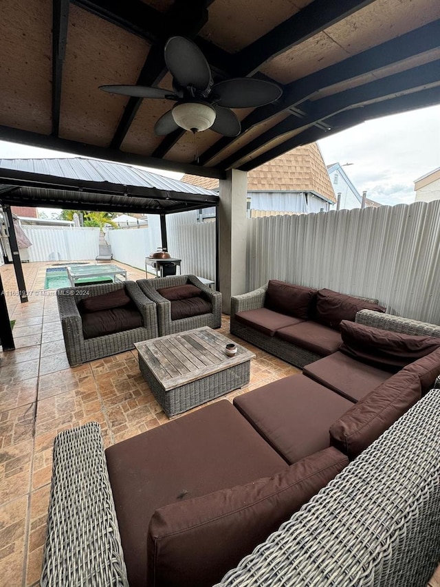 view of patio with a gazebo, a pool with hot tub, outdoor lounge area, and ceiling fan