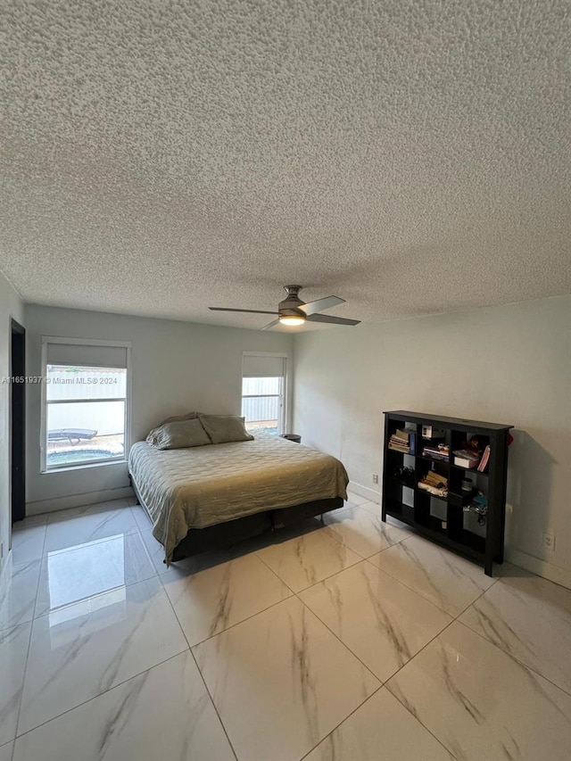 bedroom featuring a textured ceiling and ceiling fan