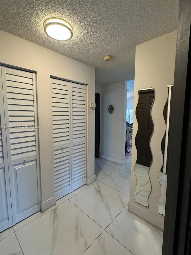 corridor with a textured ceiling