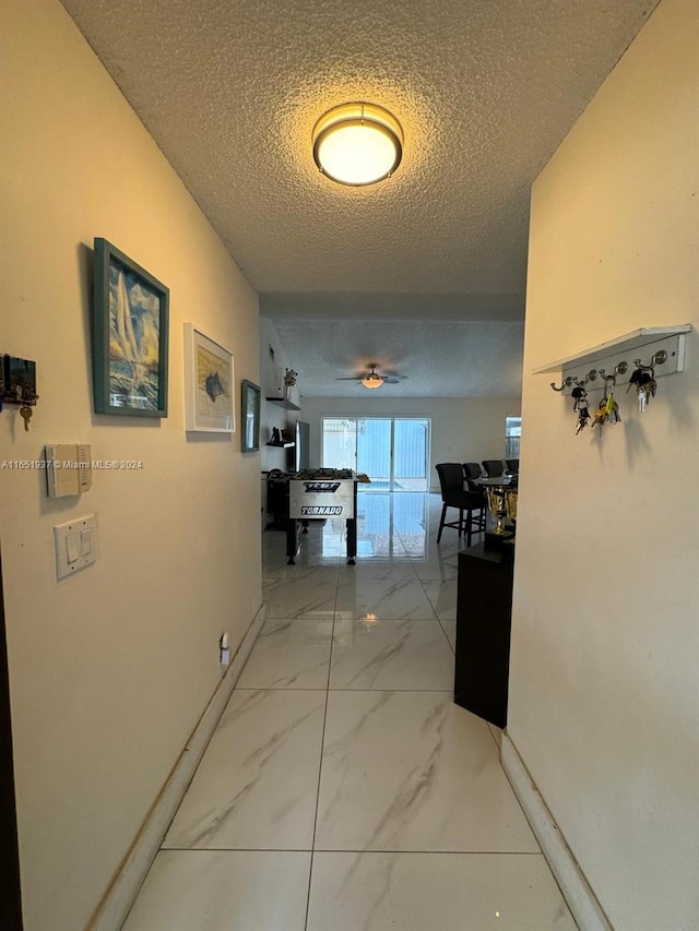 corridor with a textured ceiling