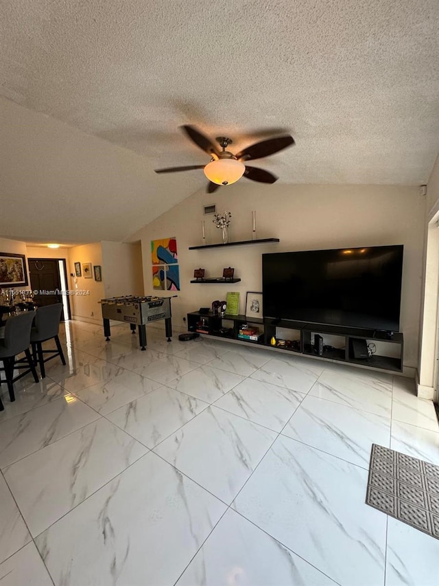 unfurnished living room with lofted ceiling, a textured ceiling, and ceiling fan