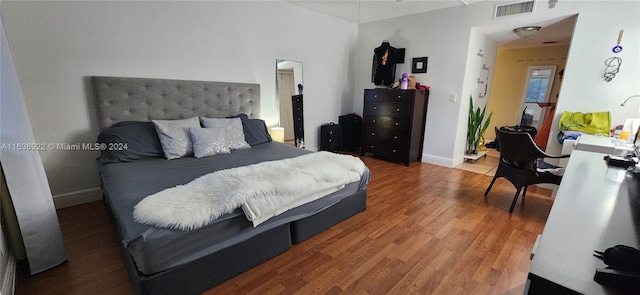 bedroom with hardwood / wood-style flooring