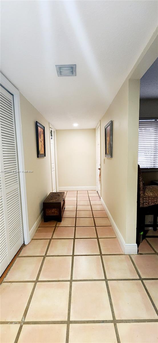 hallway featuring light tile patterned floors