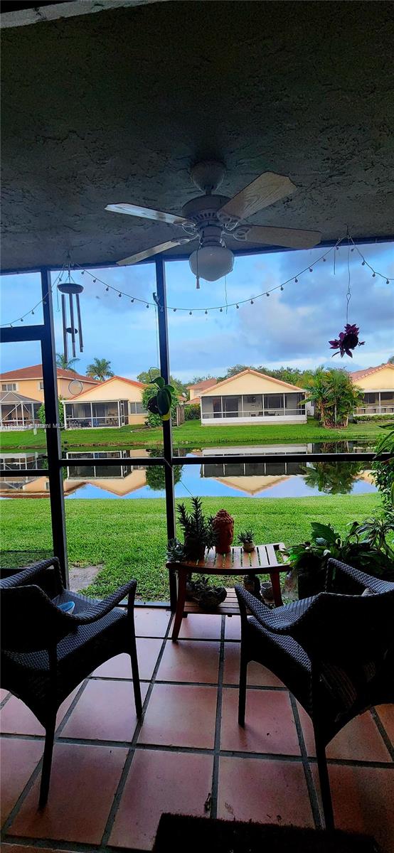 view of patio / terrace with a water view and ceiling fan