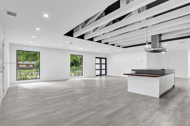 unfurnished living room featuring a healthy amount of sunlight