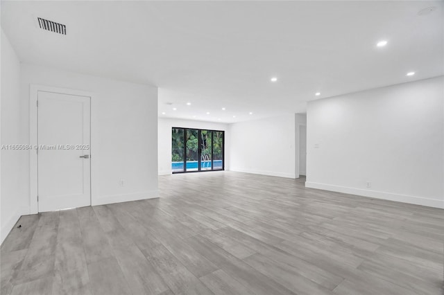 spare room featuring light hardwood / wood-style flooring