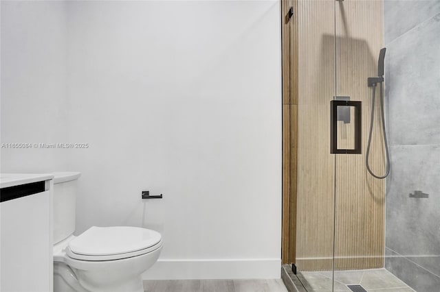 bathroom featuring walk in shower, vanity, tile patterned flooring, and toilet