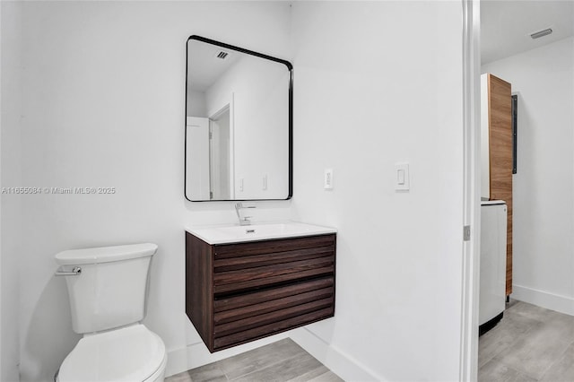 bathroom featuring toilet and vanity