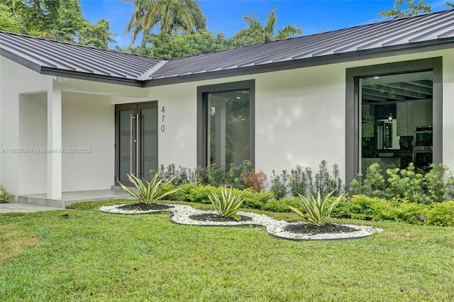 doorway to property with a yard