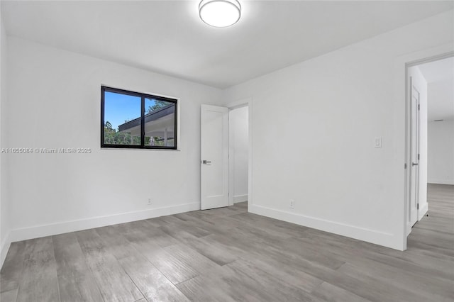 spare room featuring light hardwood / wood-style floors