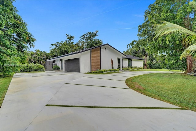 view of property exterior featuring a lawn and a garage