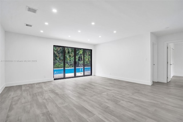 spare room with light hardwood / wood-style flooring