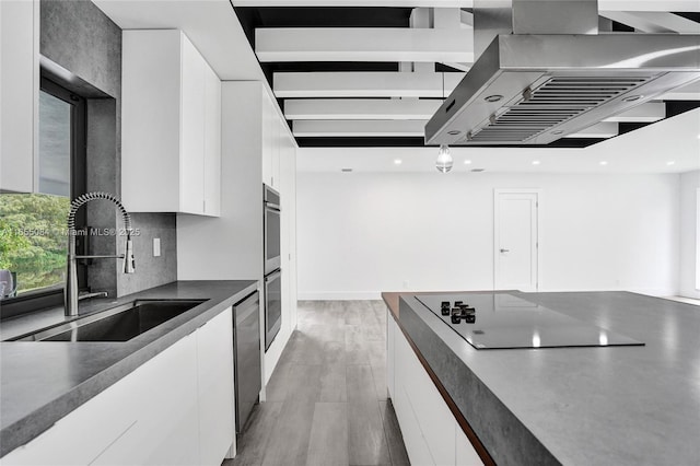 kitchen with island exhaust hood, stainless steel appliances, dark hardwood / wood-style floors, white cabinets, and sink