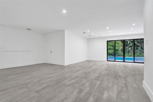 unfurnished room with light hardwood / wood-style floors