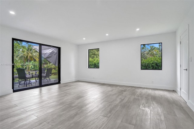 unfurnished room with light hardwood / wood-style floors