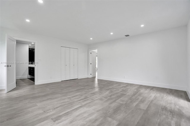 empty room with light hardwood / wood-style flooring