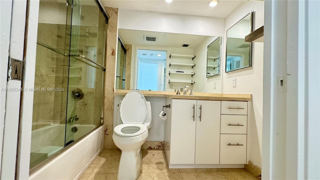 full bathroom featuring shower / bath combination with glass door, tile patterned flooring, toilet, and vanity