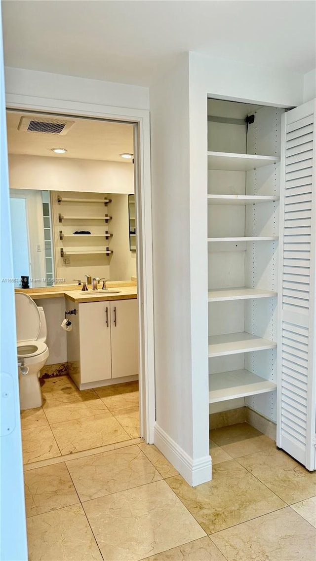 bathroom with vanity and toilet