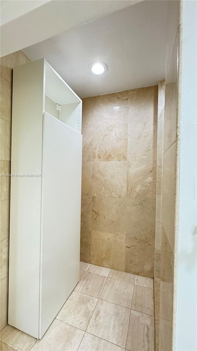 bathroom featuring tiled shower and tile patterned floors