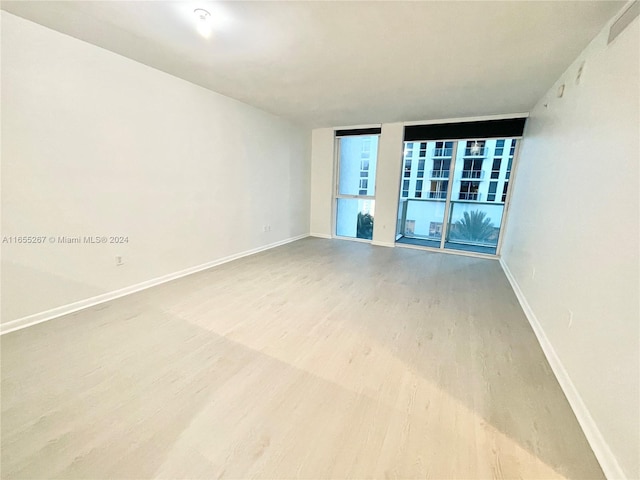 spare room with wood-type flooring