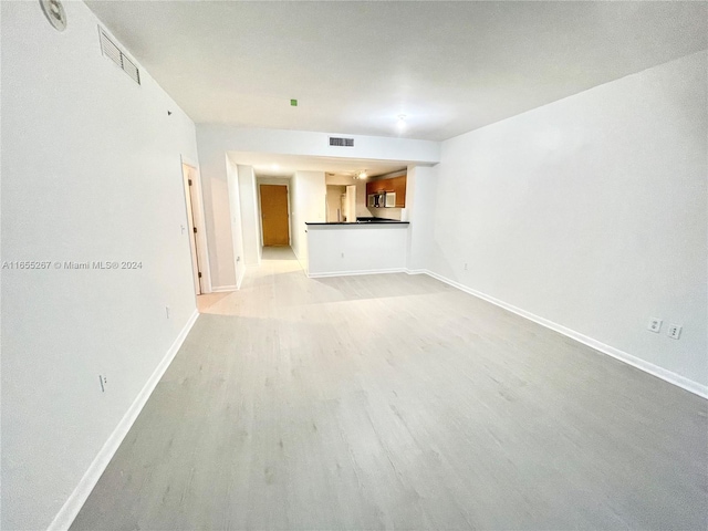 unfurnished living room with light hardwood / wood-style flooring