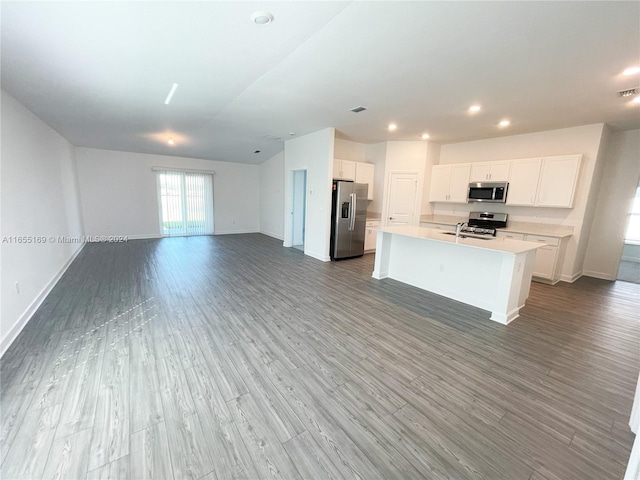 kitchen featuring light hardwood / wood-style flooring, stainless steel appliances, sink, an island with sink, and white cabinets