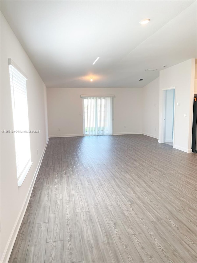 empty room with light hardwood / wood-style flooring